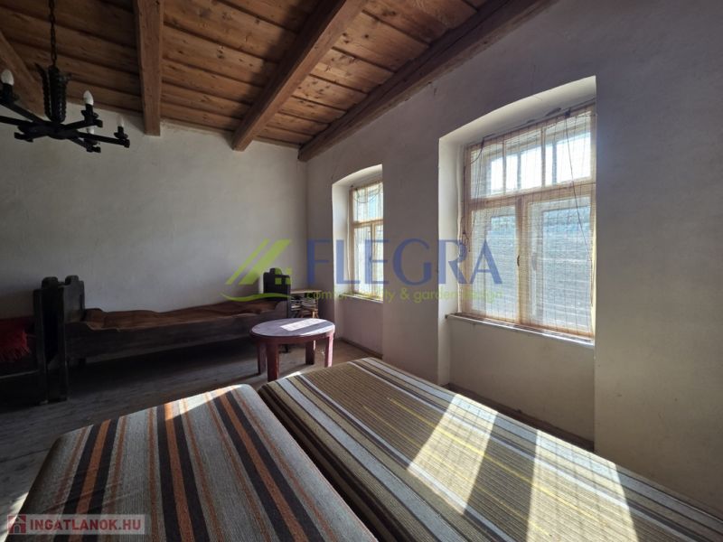 A room in a family house with wooden ceilings and natural light.