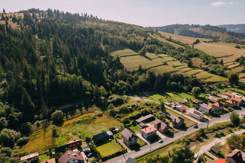 Aerial view of residential plots in Čierny Balog, Švermova, with surrounding forest.