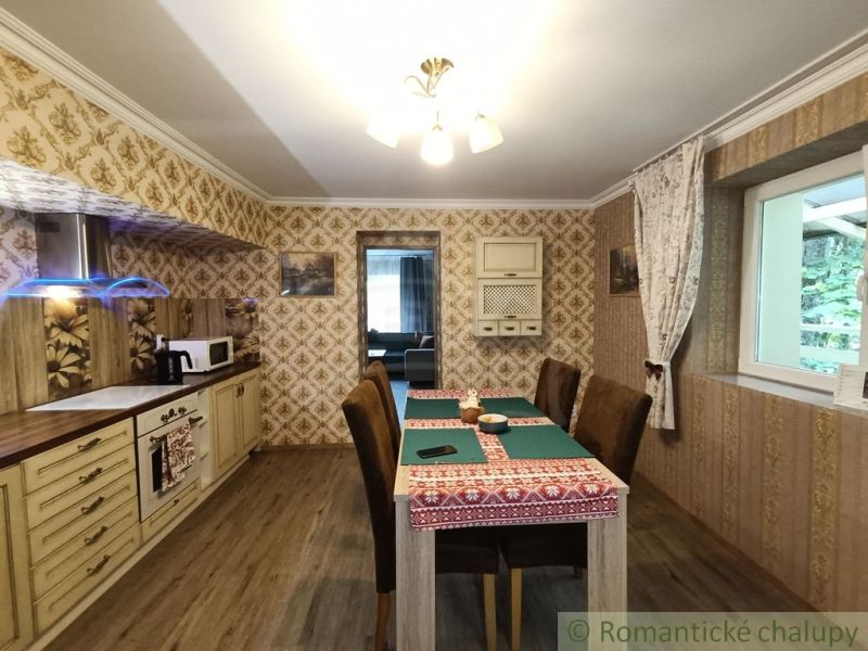 Interior of a family house with a wooden decor floor, dining table, and wallpapers.