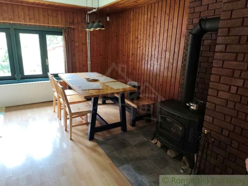 Interior of a cabin with a fireplace and a wooden decor floor.