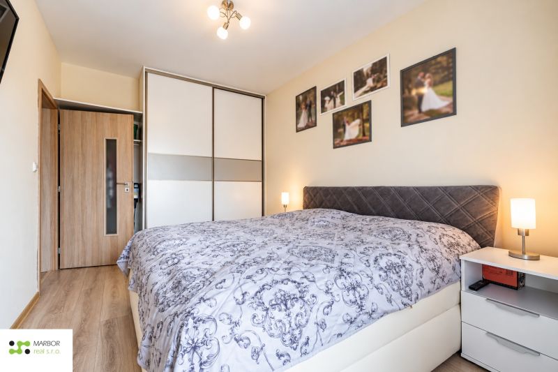Bedroom with a built-in wardrobe, in a 3-room apartment; floor with wood decor.
