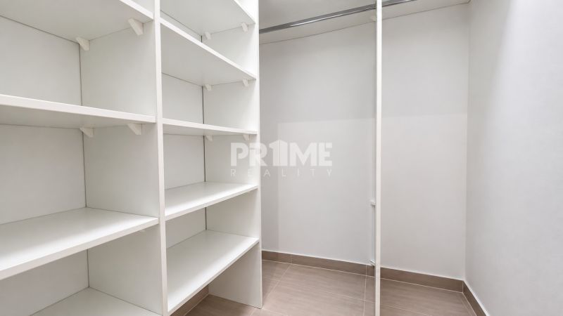 Storage space with white shelves in a 2-room apartment.