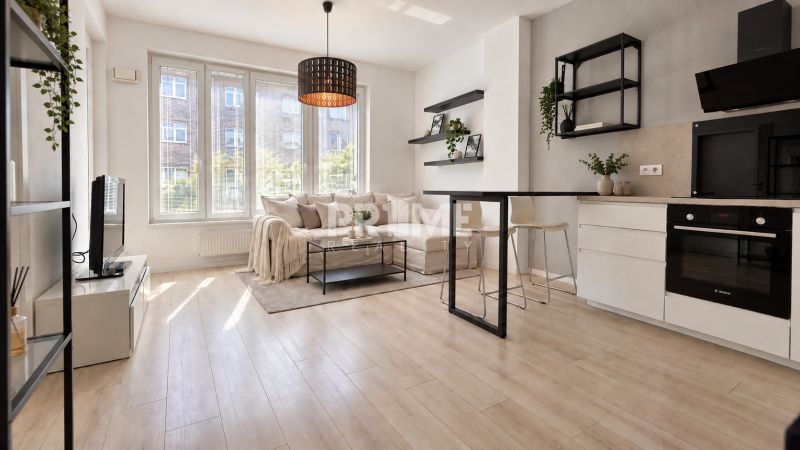 Living room with kitchen, sofa set, and wooden decor flooring in a two-room apartment.