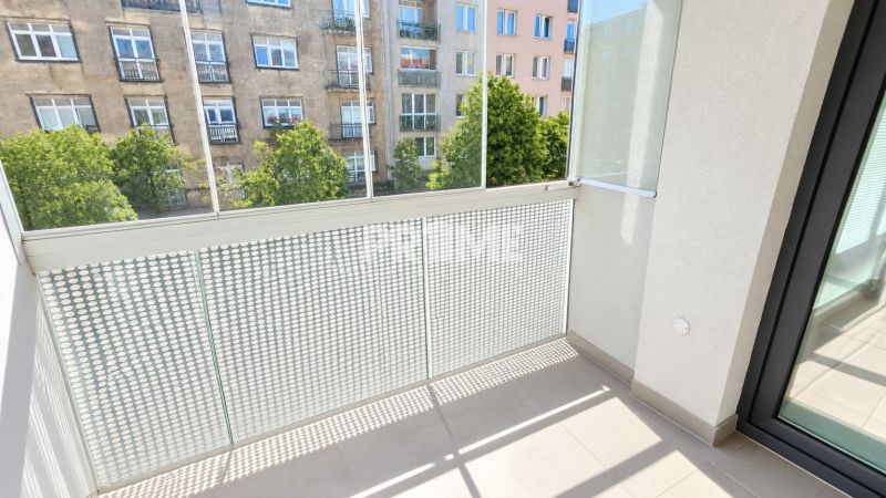 A balcony with a view of the street in a 2-room apartment with modern railings.