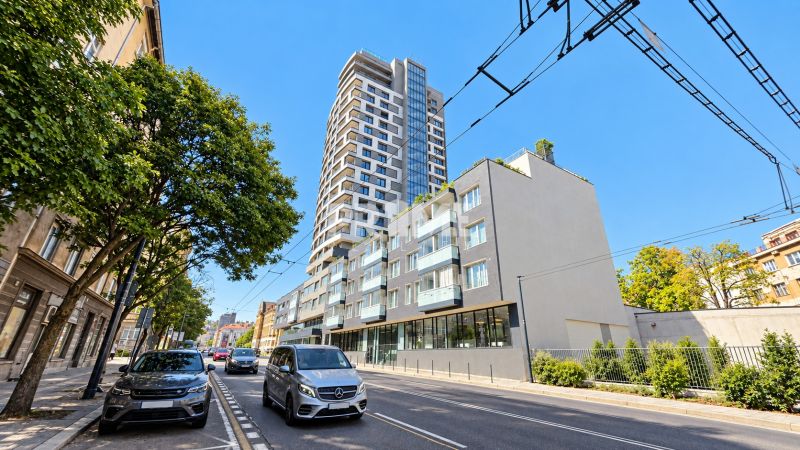 Šancová Street in Bratislava - Staré Mesto with a modern high-rise building and greenery.