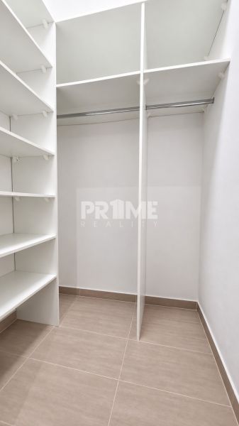 A wardrobe with shelves and a hanging rod in a 2-room apartment.