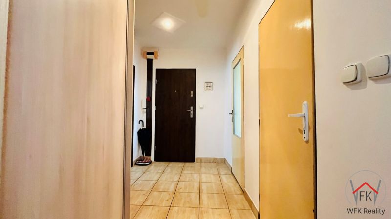 Hallway in a 3-room apartment with tiles, doors, and a built-in wardrobe.