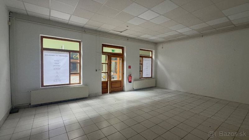 Commercial spaces with tiles and large windows, waiting to be utilized.
