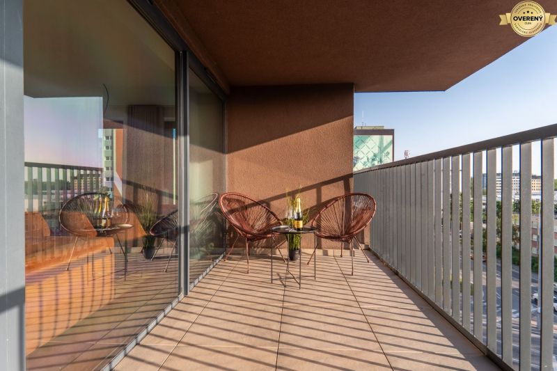 Balcony of apartment construction with seating and a view of Bratislava - Ružinov, Mierová.