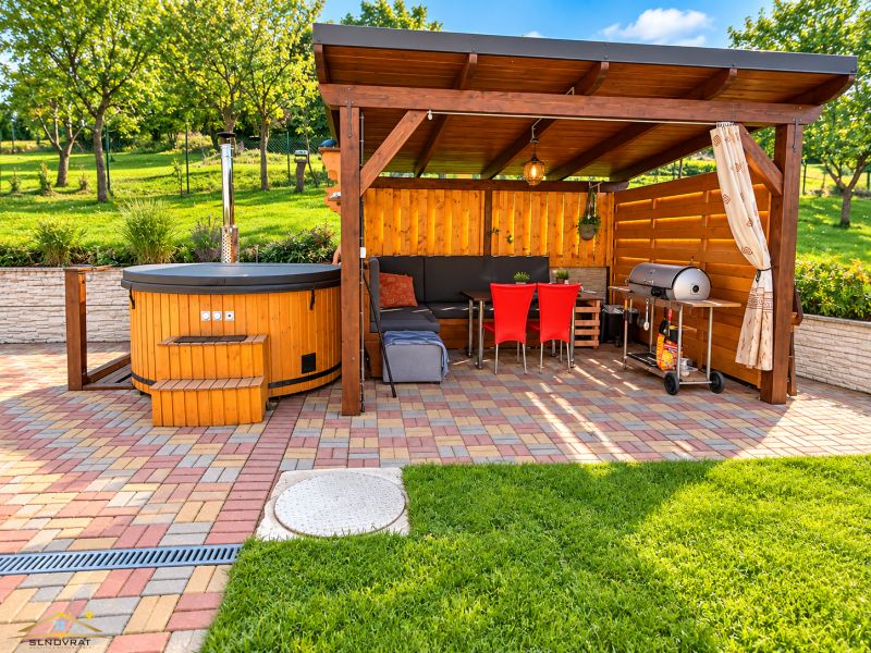 A gazebo with seating and a grill at a family house in Oščadnica on Košariská Street.