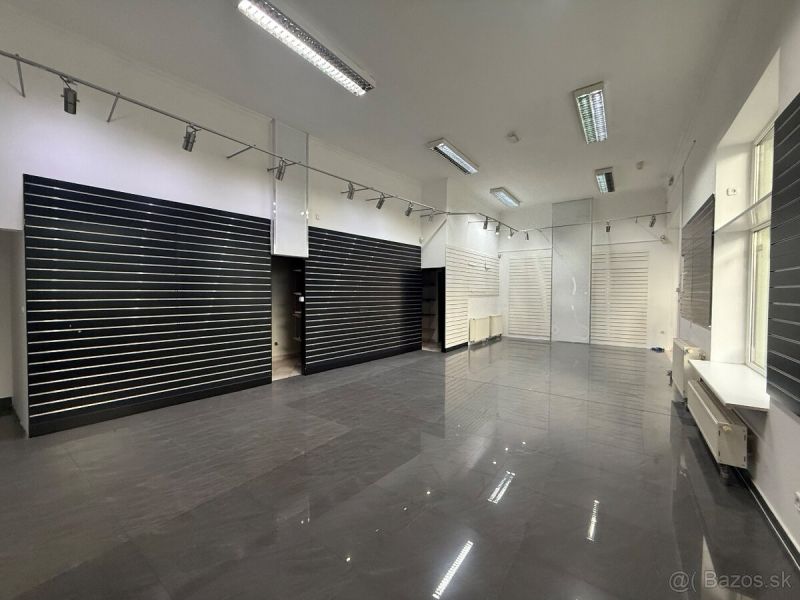 Commercial premises with a shiny floor, built-in lights, and slatted walls.
