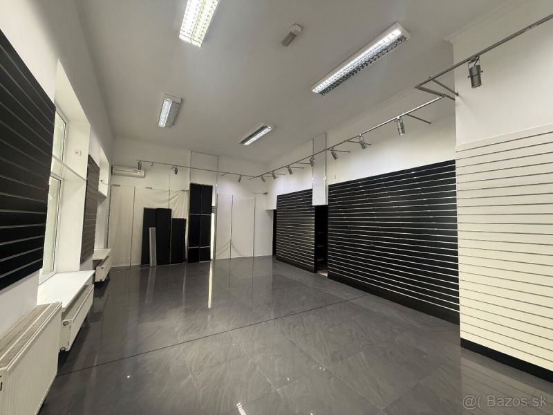 Commercial premises with dark walls and gray tiles, available for rent.