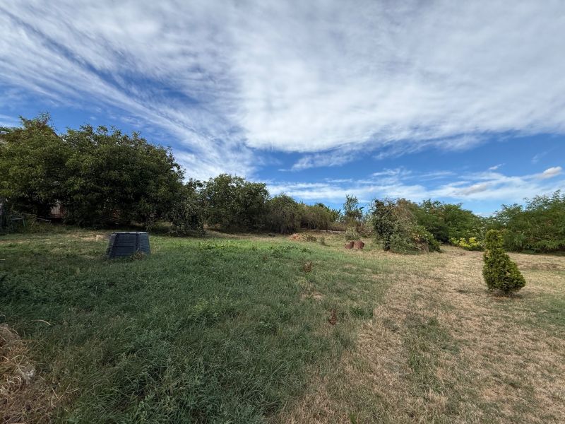 Plots - living in Krušovce with greenery and a vast grassy area under the blue sky.