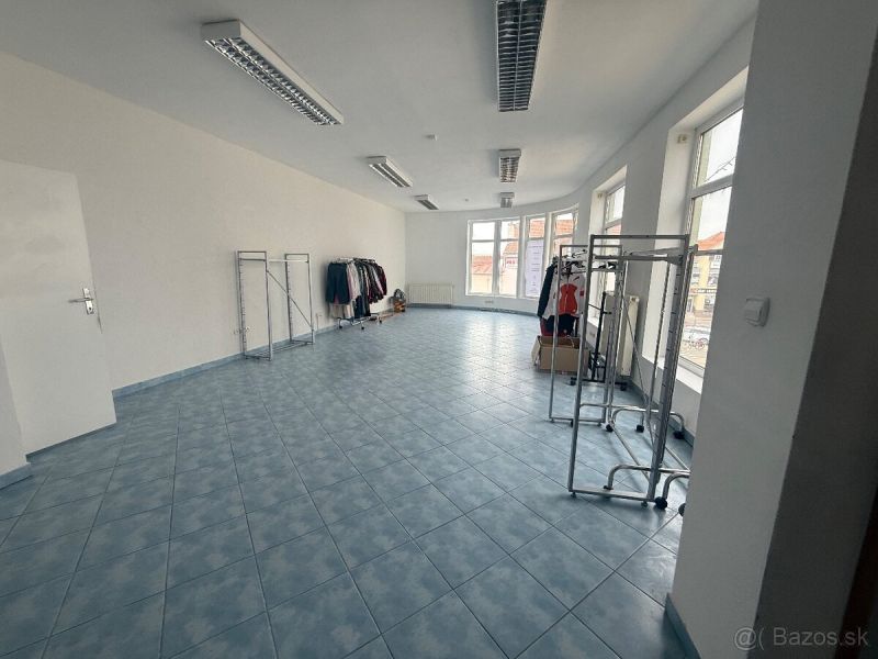 Retail spaces with blue tiles and clothing racks.