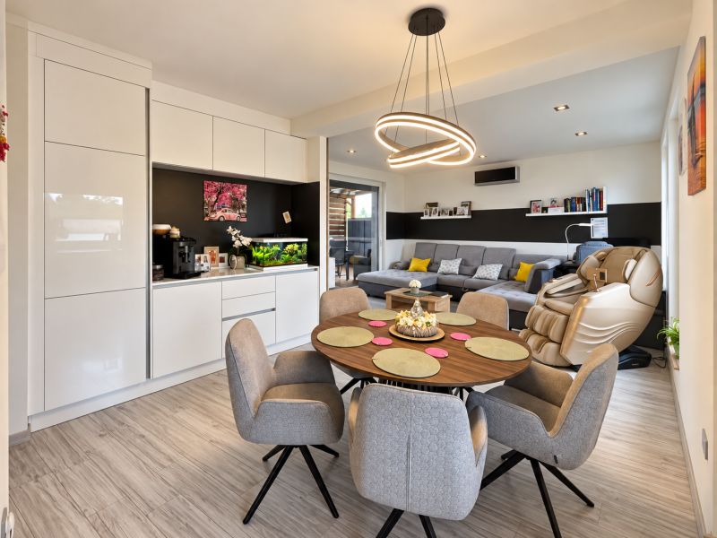 Living room in a family house with wood-patterned flooring and comfortable seating.