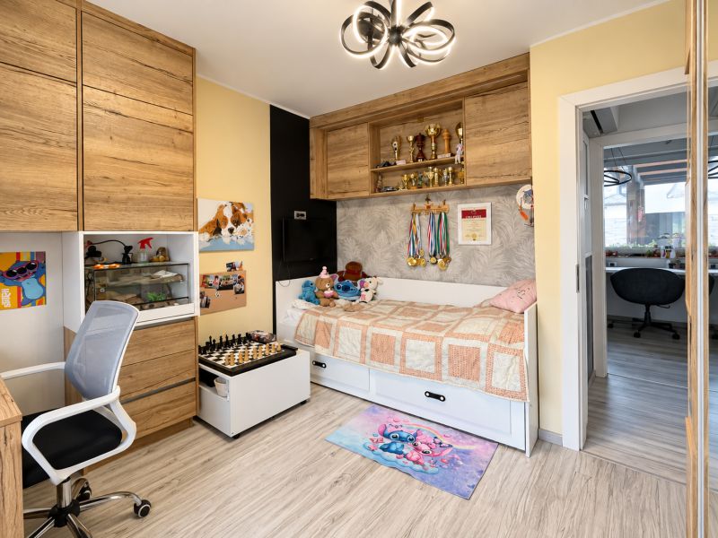 Children's room with wooden decor cabinets and decorations in a family house.