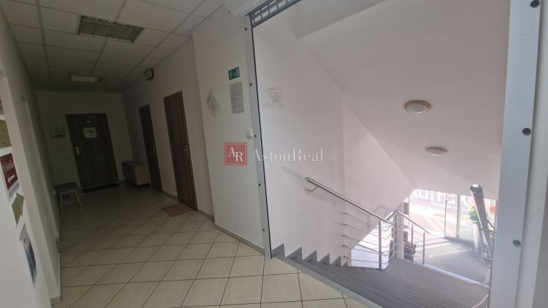 Interior of an office with a spacious staircase and tiles, in a quiet environment.