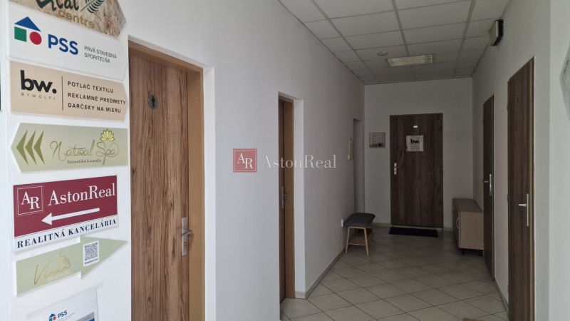 Offices with white walls and doors with wood decor for various companies.