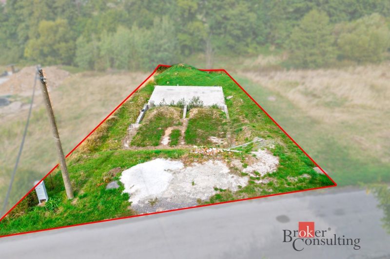 A plot for residential use in Detva with concrete foundations and a grassy surface in a natural environment.