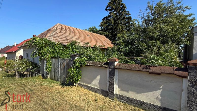 A house surrounded by greenery on Štefánikova Street in Krušovce, ideal for residential land.