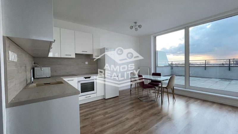 Kitchen and dining area in a 2-room apartment with a wooden decor floor and a terrace.