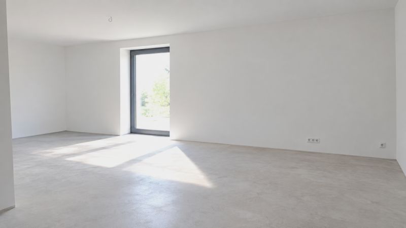 A spacious room in a family house with large windows and white walls.