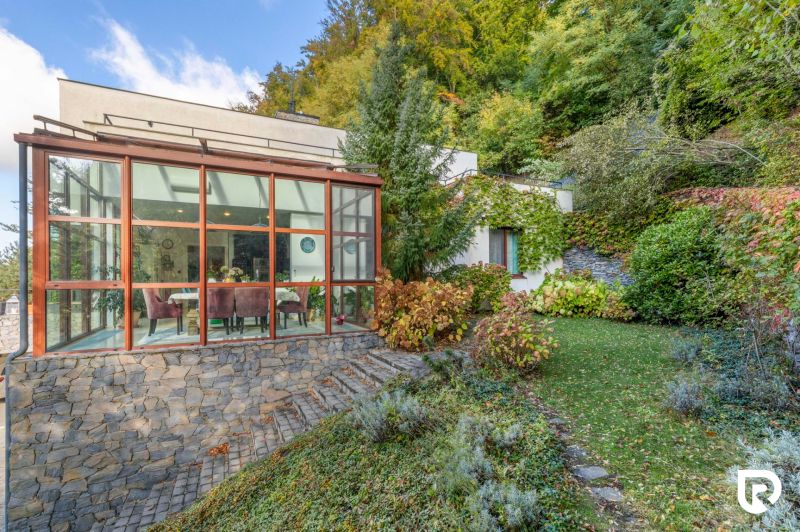 A family house on Karpatská Street in Marianka with a glazed winter garden and a landscaped garden.