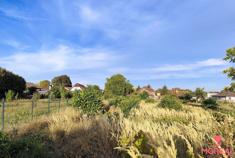 Plots for residential development in Jasová with views of houses and awakening nature.
