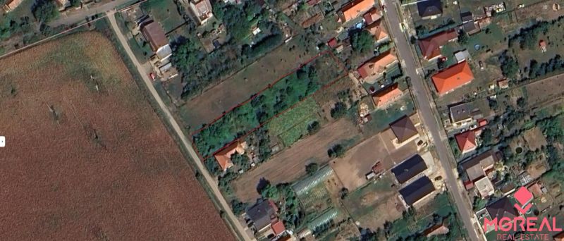 Residential plots in Jasová with marked area, surrounded by greenery and buildings.
