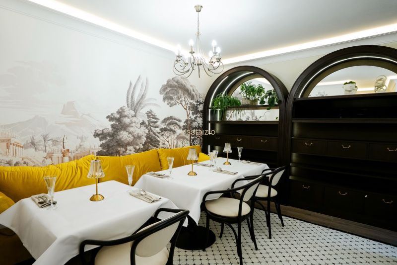Luxury commercial spaces with a colorful sofa, decorative wallpaper, and elegant serving.