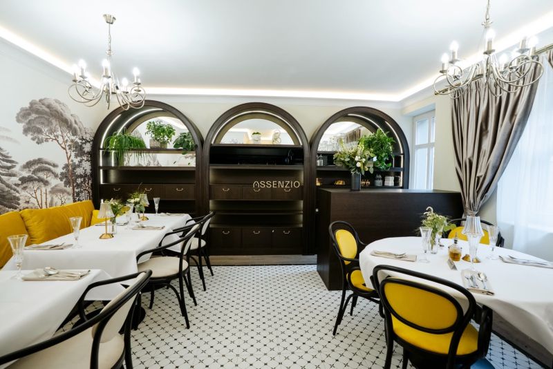 Stylish commercial spaces with elegant furniture, curved shelves, and yellow accents.