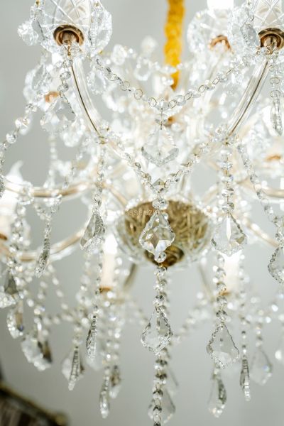 A luxurious chandelier with crystal drapes hangs in the commercial premises.