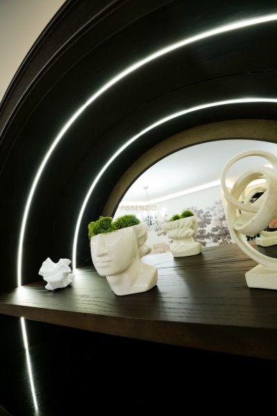 Decorative figurines in commercial spaces with wood-patterned flooring and lighting.