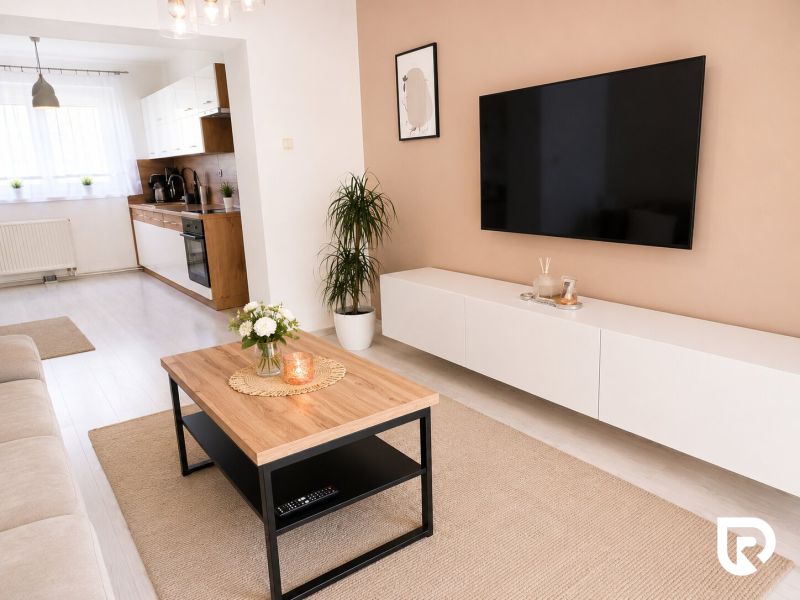 Living room in a 2-room apartment with a wooden decor floor and modern furniture.