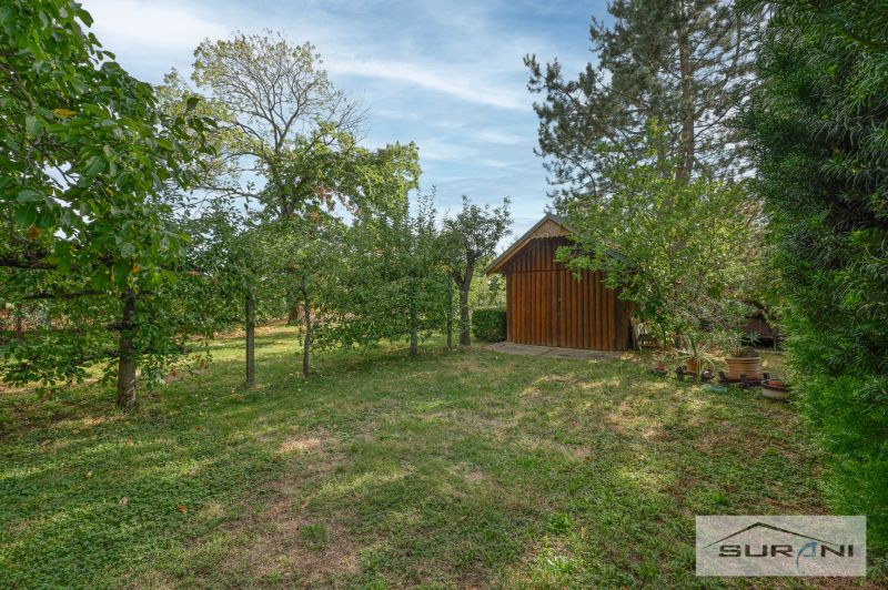 Garden with a lawn and a wooden structure on Hlavná Street in Štefanová.