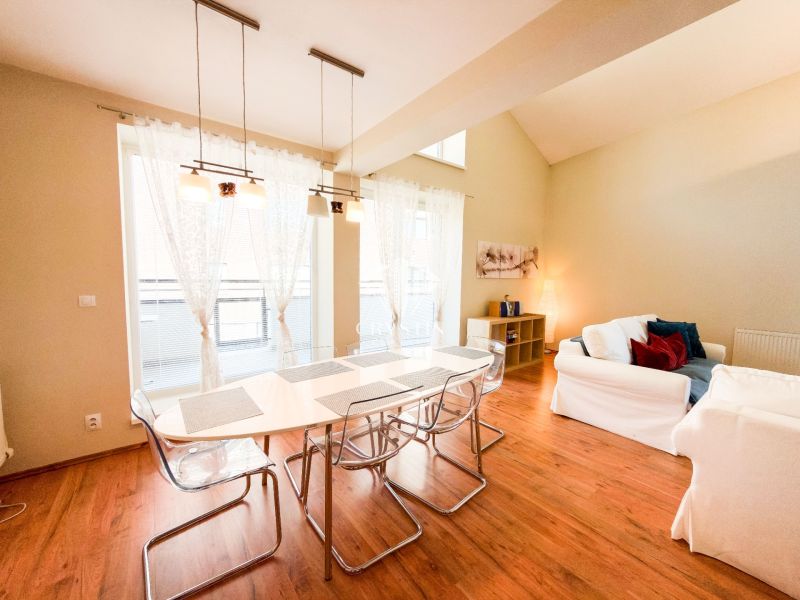 Living room with large windows, sofas, and a wooden decor floor in a 3-room apartment.