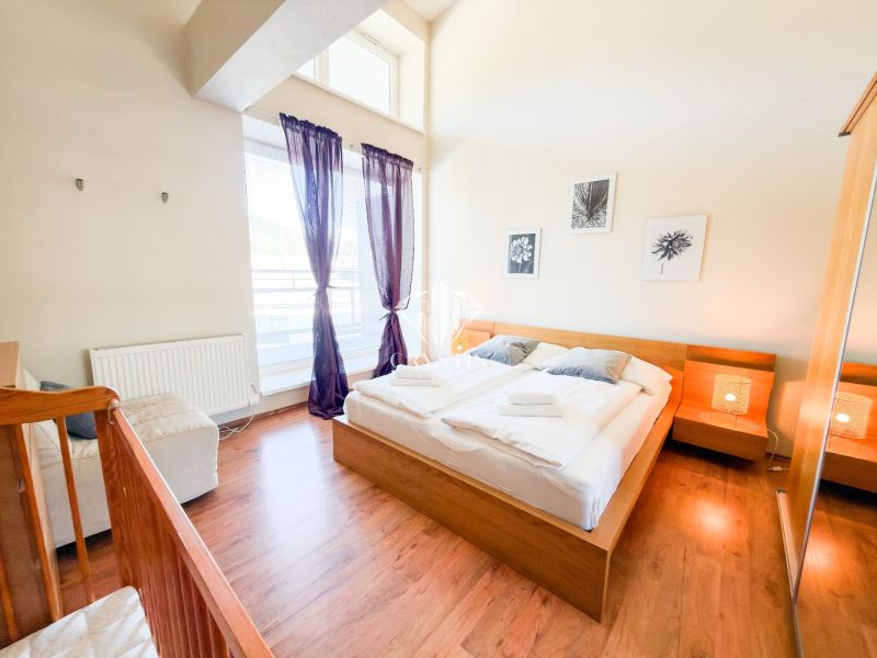 A bright bedroom with wood-patterned flooring in a 3-room apartment, pleasant atmosphere.