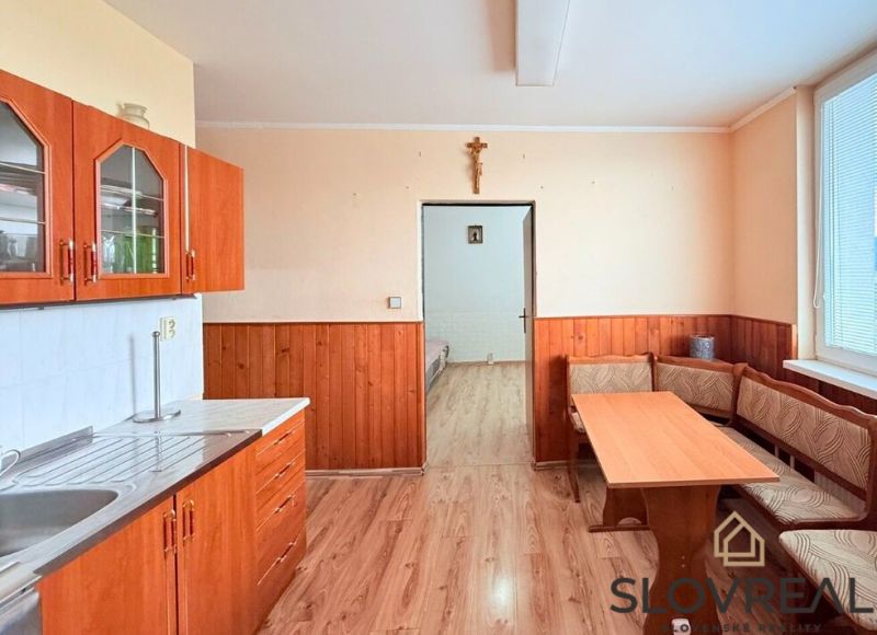 A kitchen in a 3-room apartment with a kitchen unit and a dining table.