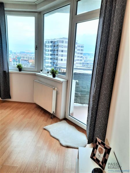 Large windows in a 2-room apartment with a wooden decor floor.