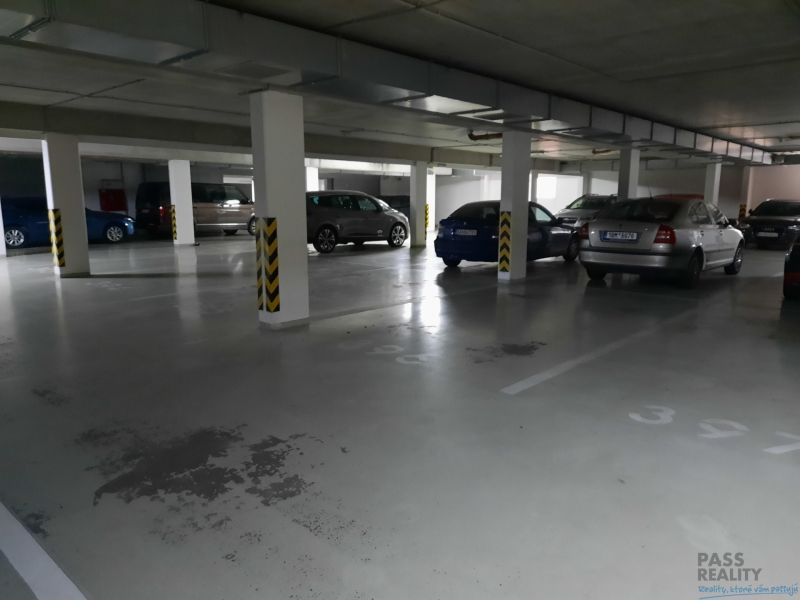 Underground garage parking space with parked cars in a 2-room apartment.