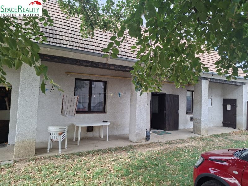 In front of the house on Hlavná Street in Viničné, plots - residential, there are tables.