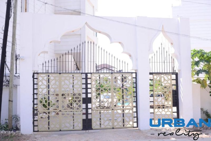 Entrance gate at a 2-room apartment on Mbweni Street in Zanzibar with decorative metal elements.