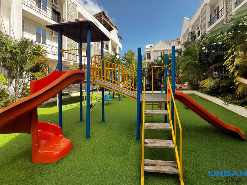Playground on Mbweni Street in Zanzibar with climbing frames and slides.