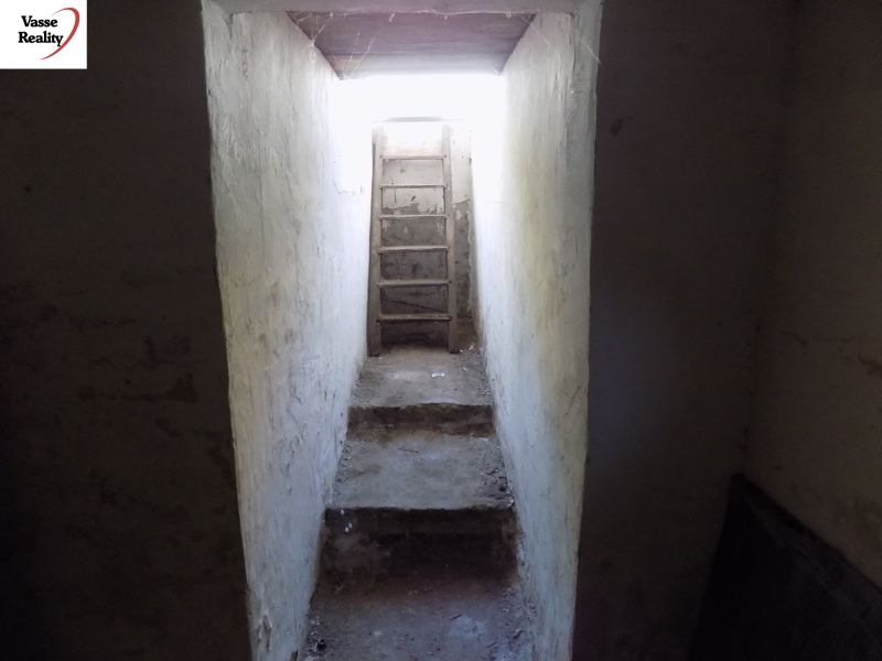 Narrow stairs in the garages leading to the light through a narrow passage.