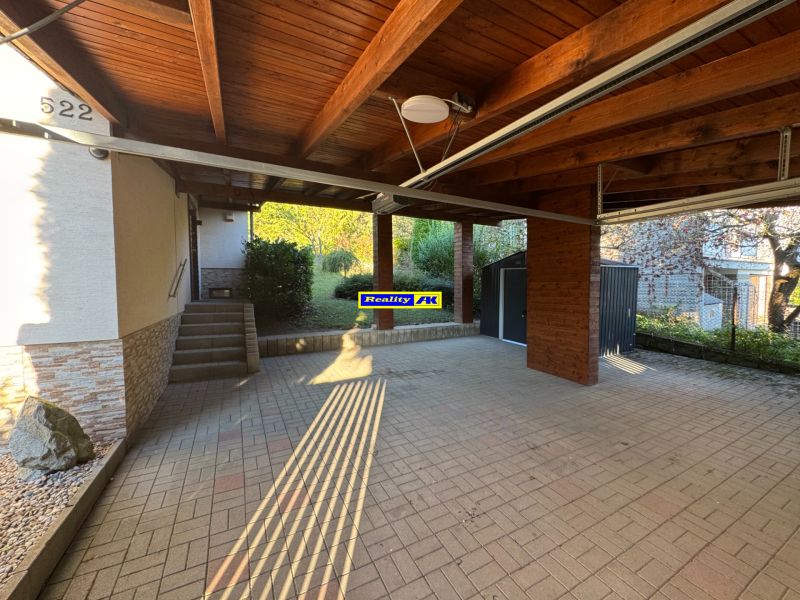 Garage and entrance to the family house at Valča 533, Valča, with a paved area.
