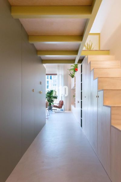 A cozy hallway with storage space and a staircase in a 2-room apartment.