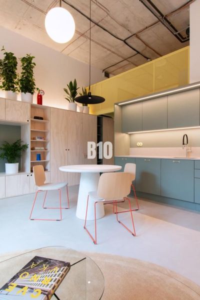 Compact kitchen and dining area with a round table in a 2-room apartment.
