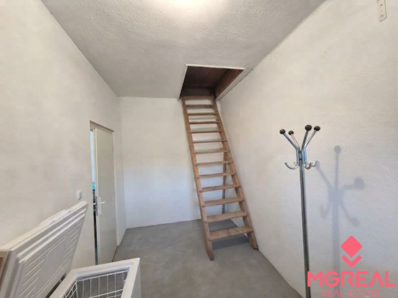 Attic storage space with a wooden ladder in a family house.
