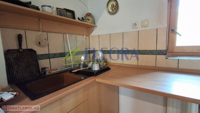 A kitchen nook in a family house with a wooden decor and a window.