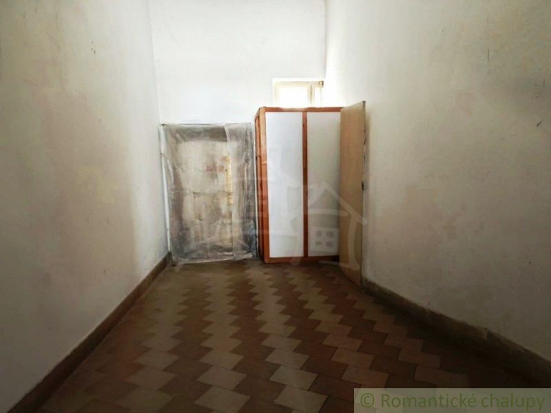A narrow space with a wooden decor floor and storage space in commercial premises.